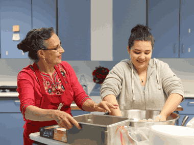 Carmen Gonzalez and Student cooking tortillas in a classroom kitchen